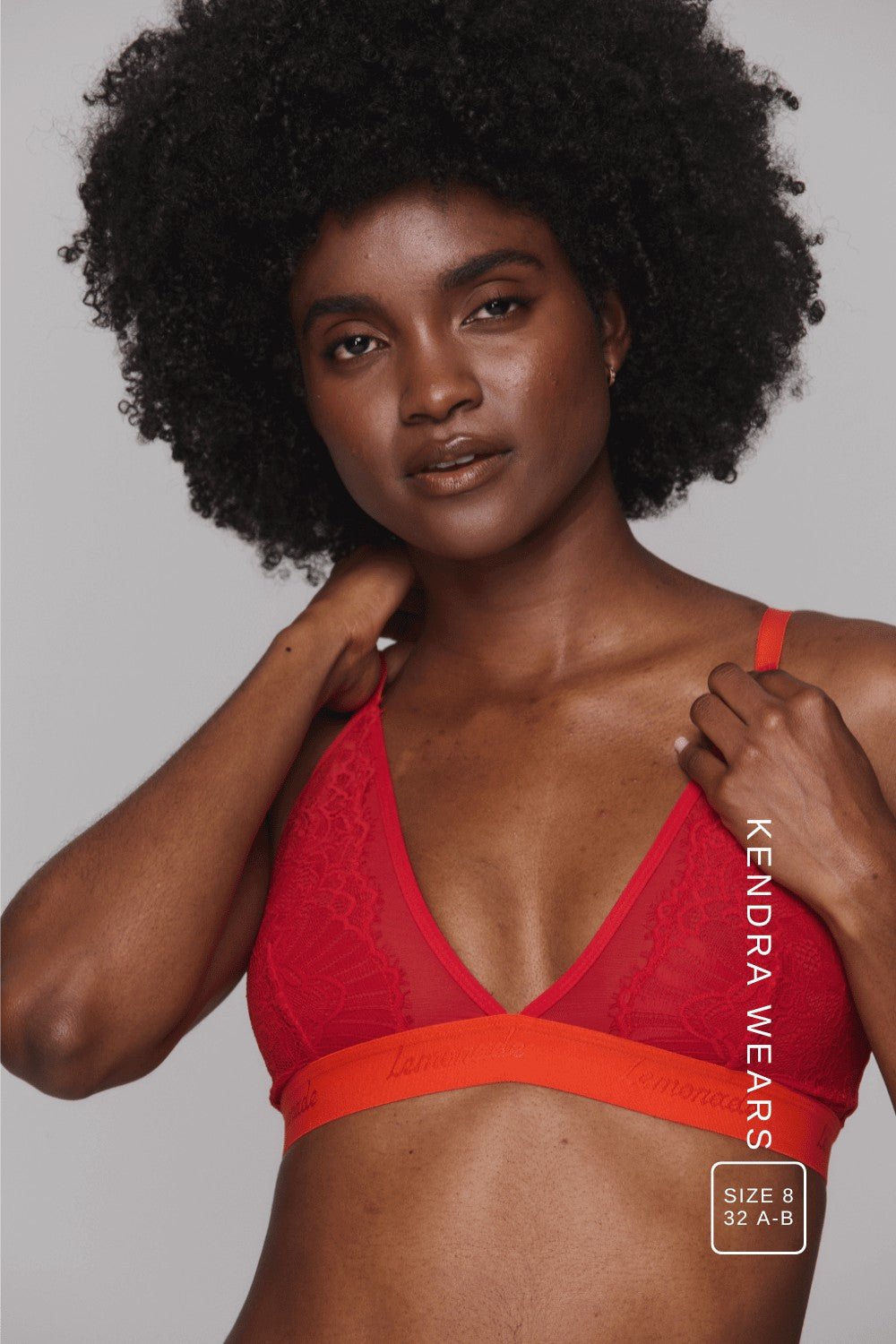A woman wearing a red lace bralette with orange straps ^Kendra | Size: 32 A-B / 8