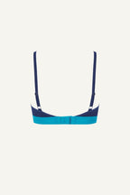 A ghost image of the back of a blue lace bralette 