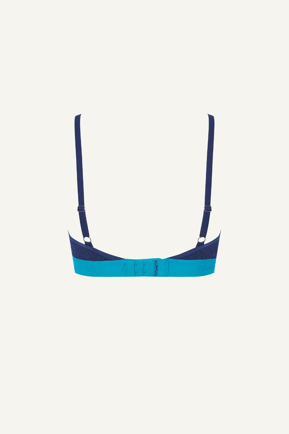 A ghost image of the back of a blue lace bralette 