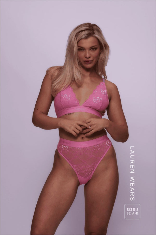 A woman wearing a pink lace bralette paired with the matching briefs Lauren | Size: 32 A-B  / 