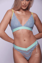 A woman wearing a blue lace brazilian with a matching bralette 