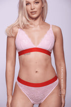 A woman wearing a light pink ace lingerie set with red details ^Lauren | Size: 32 B / 8