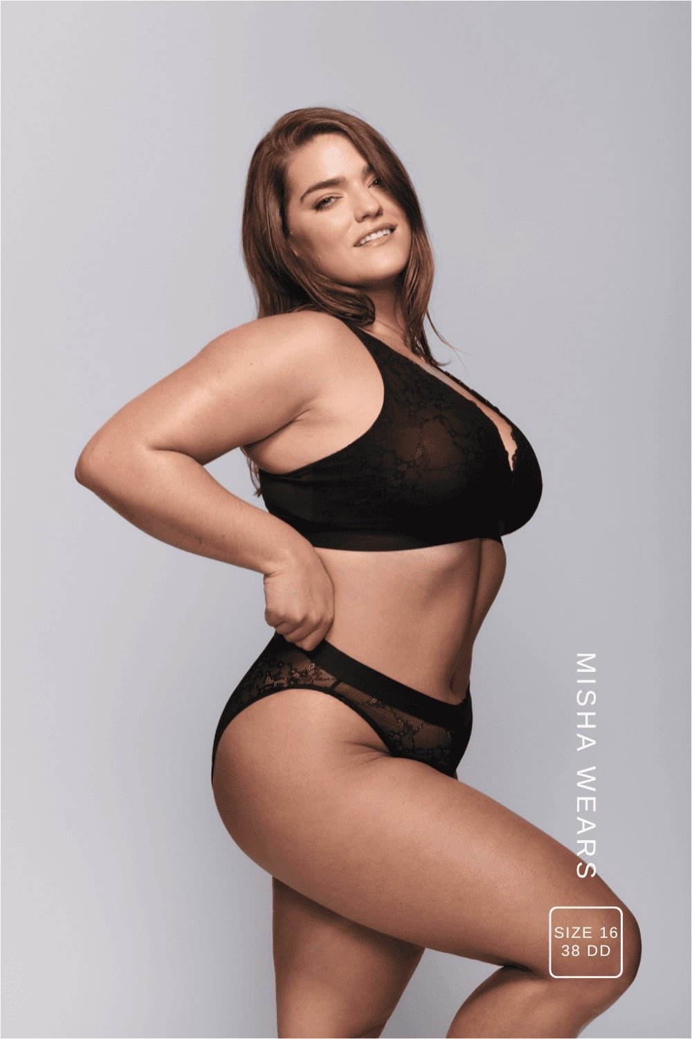 A woman standing with her side to wearing a black lace lingerie set ^Misha | Size: 38 DD / 16