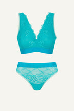 Teal lace lingerie set on a light gray background
