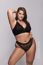 A woman wearing a matching black lace lingerie set 