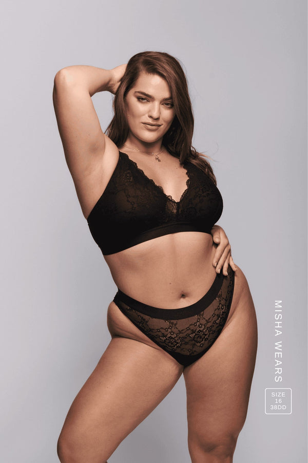 A woman wearing a matching black lace lingerie set 