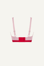 A ghost image of the back of a light pink and red lace fuller cup bralette 