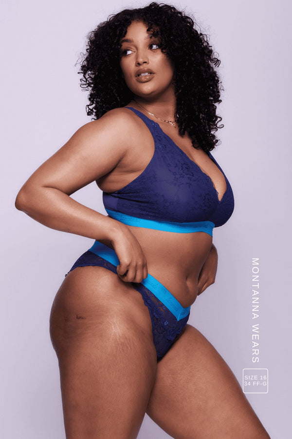 a woman wearing a dark blue matching lingerie set 