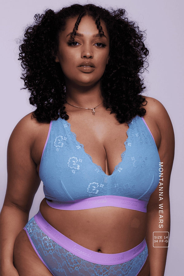 A woman wearing a blue and pink lace fuller cup bralette 