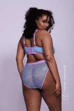 A woman modelling a light blue fuller cup lace bralette with matching briefs 
