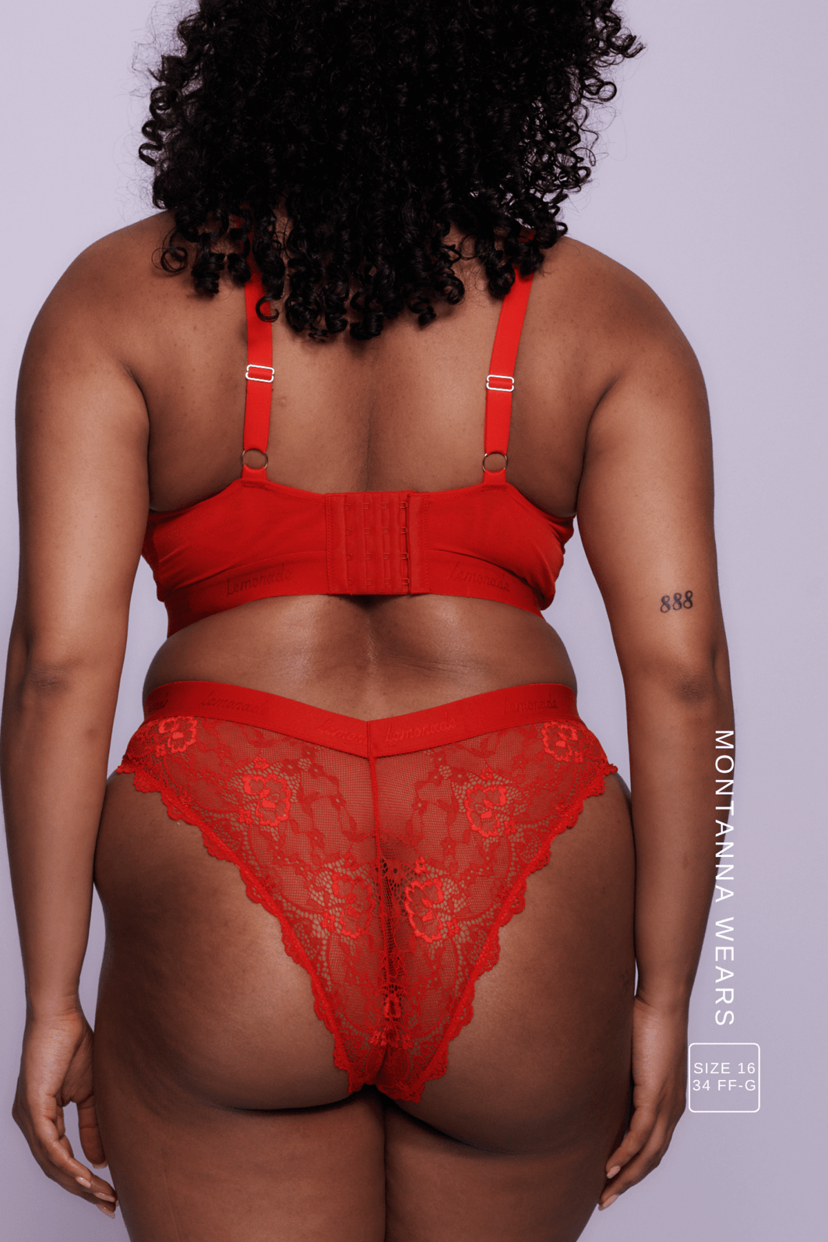 A woman standing with her back to wearing a red lace brazilian ^Montanna | Size: 34 FF-G  / 14