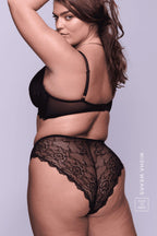 A woman modelling a Black Lace Short paired with a Black Lace Bralette ^Misha | Size: 38 DD / 16