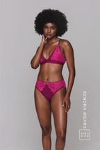 A woman wearing a pink lace lingerie set with green details ^Kendra | Size: 32 A-B / 8
