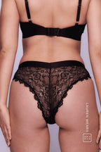 A close up image of a woman from the back, wearing a black lace brazilian 