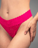 a woman wearing a pink stretch lace thong 