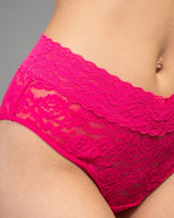 Bright pink lace panties shown on a model, featuring a wide floral lace waistband and sheer mesh front panel.