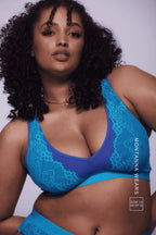 A woman modelling a blue lace fuller cup bralette 