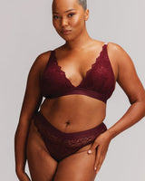A woman wearing a wine signature lace bralette and brief 